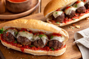 Meatball sandwich with tomato sauce and cheese on a hoagie roll
